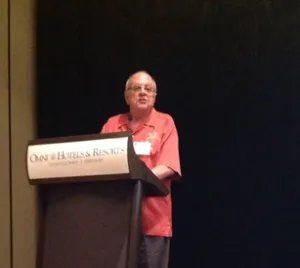 Dr. Dennis Mileti speaking from a podium